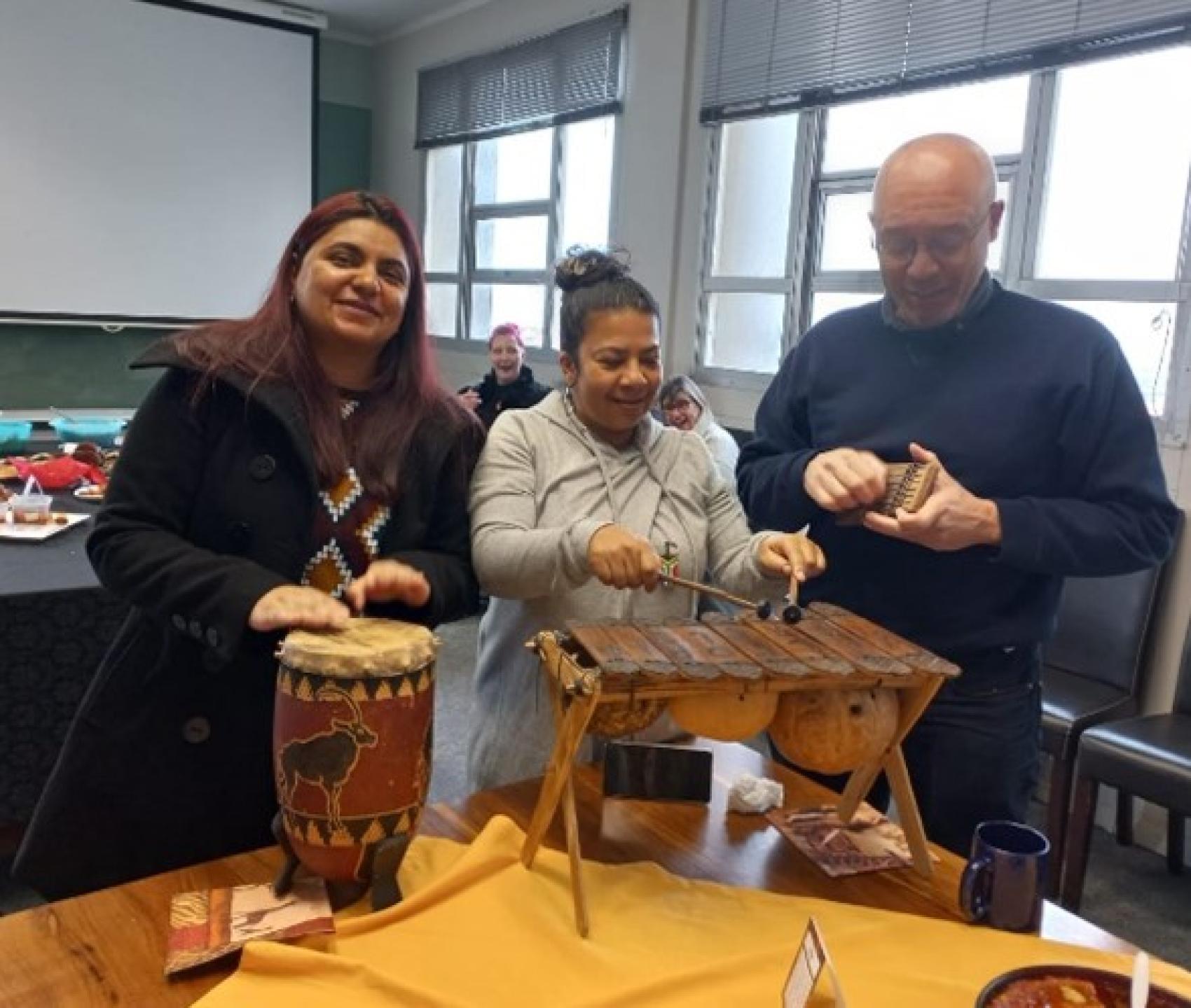 Roxanne, Deirdre and Greg trying out the instruments