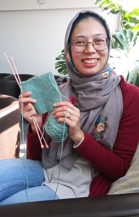 Laa-iqa holding up her knitting