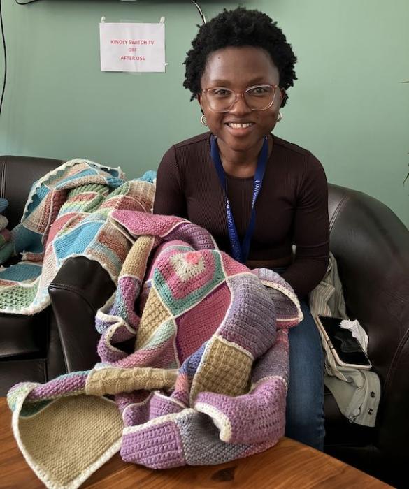 Gciniwe showing off her knitting