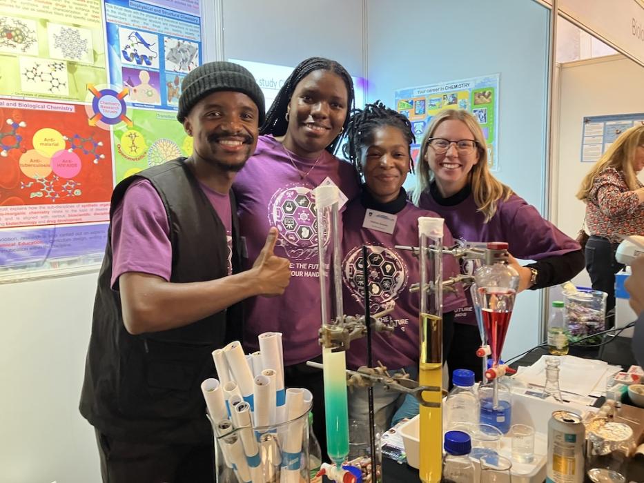 Postgraduate students pose for a picture at the chemistry exhibition table at UCT Open Day