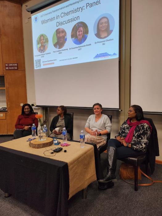 Panel discussion on women in chemistry with four panelists and event title on screen.