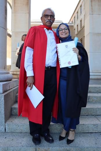 Graduant with her supervision on steps at UCT 