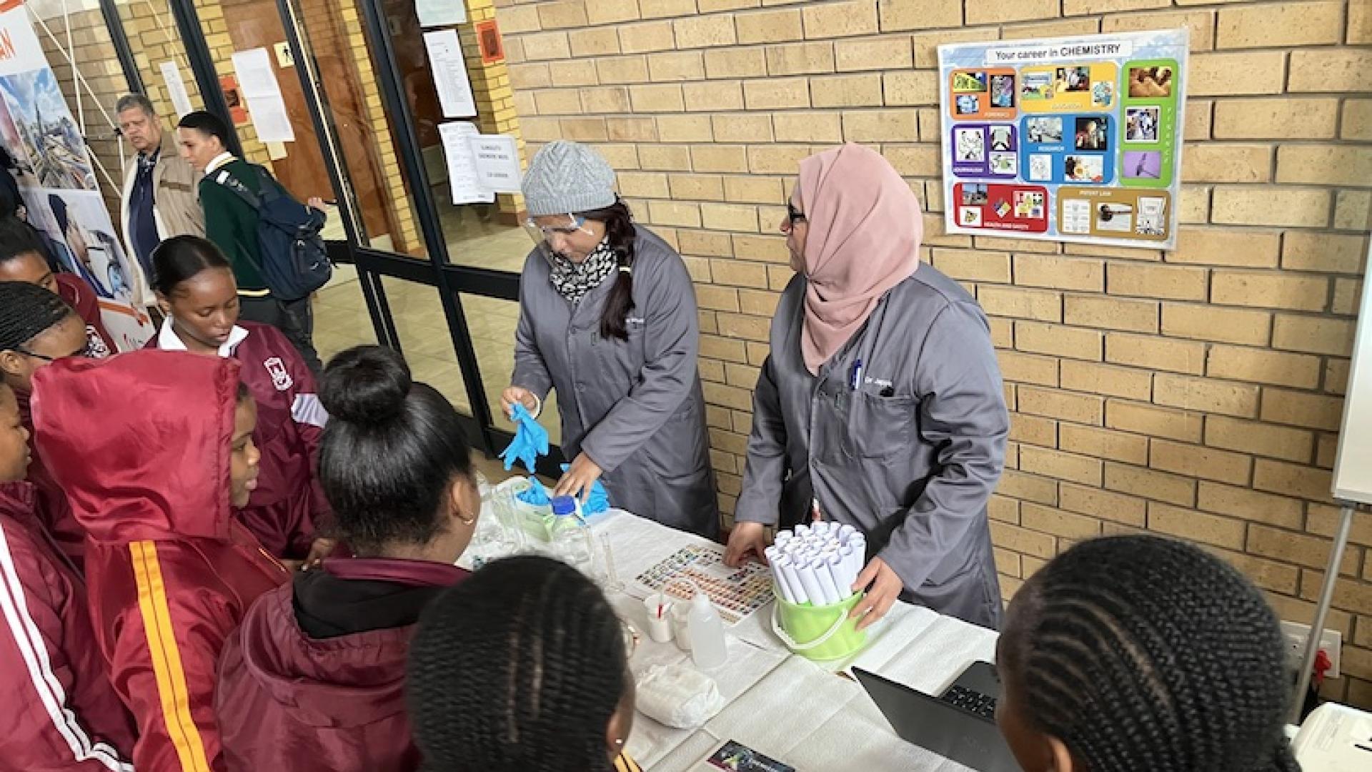 Two scientists showing learners some fun chemistry experiments