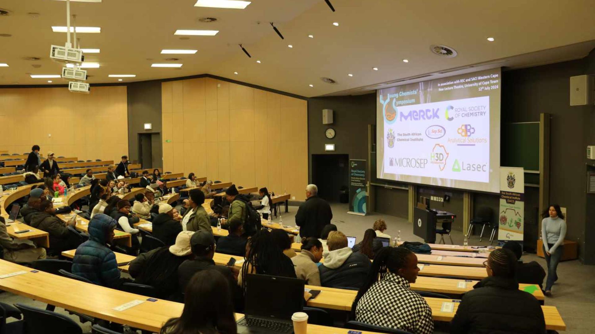 Attendees entering the lecture venue and eagerly waiting for the programme to start.
