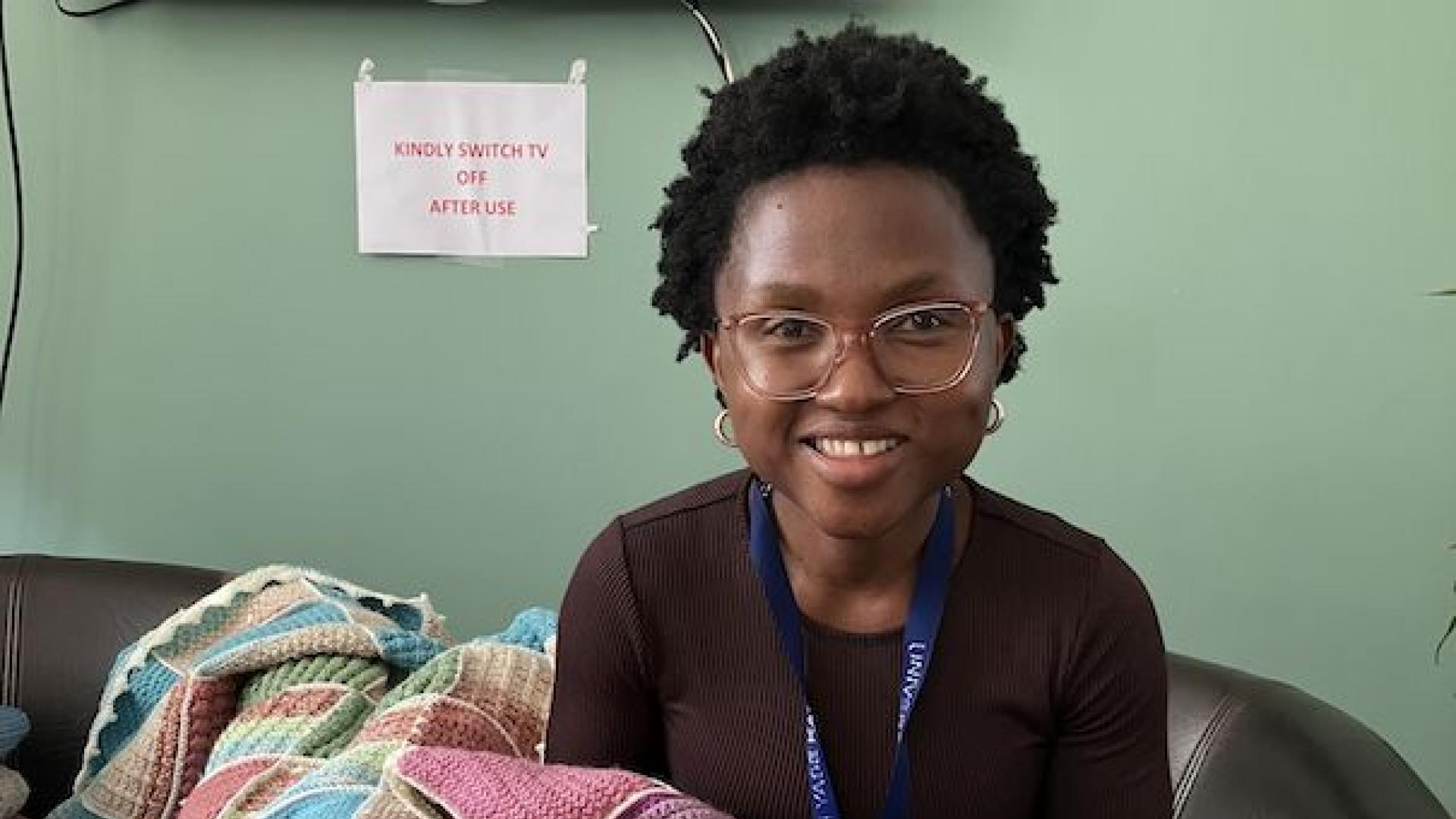 Gciniwe showing off her knitting