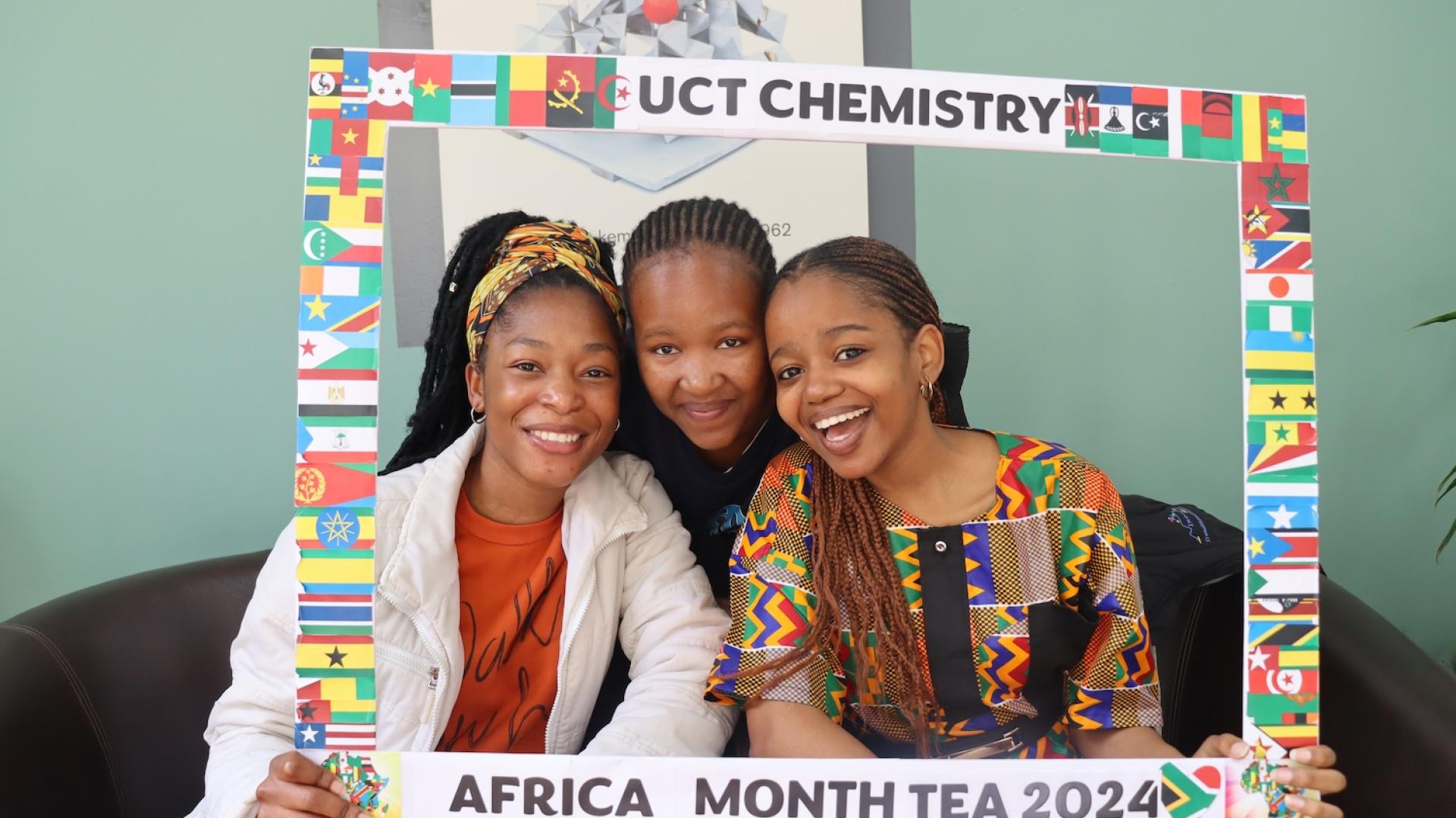 Postgraduate Students and Staff posing with the UCT Chemistry Africa Month Tea 2024 Banner