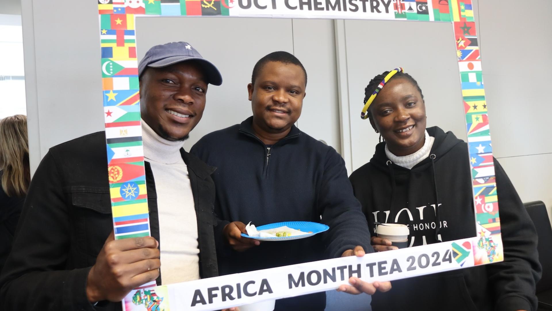Postgraduate Students and Staff posing with the UCT Chemistry Africa Month Tea 2024 Banner
