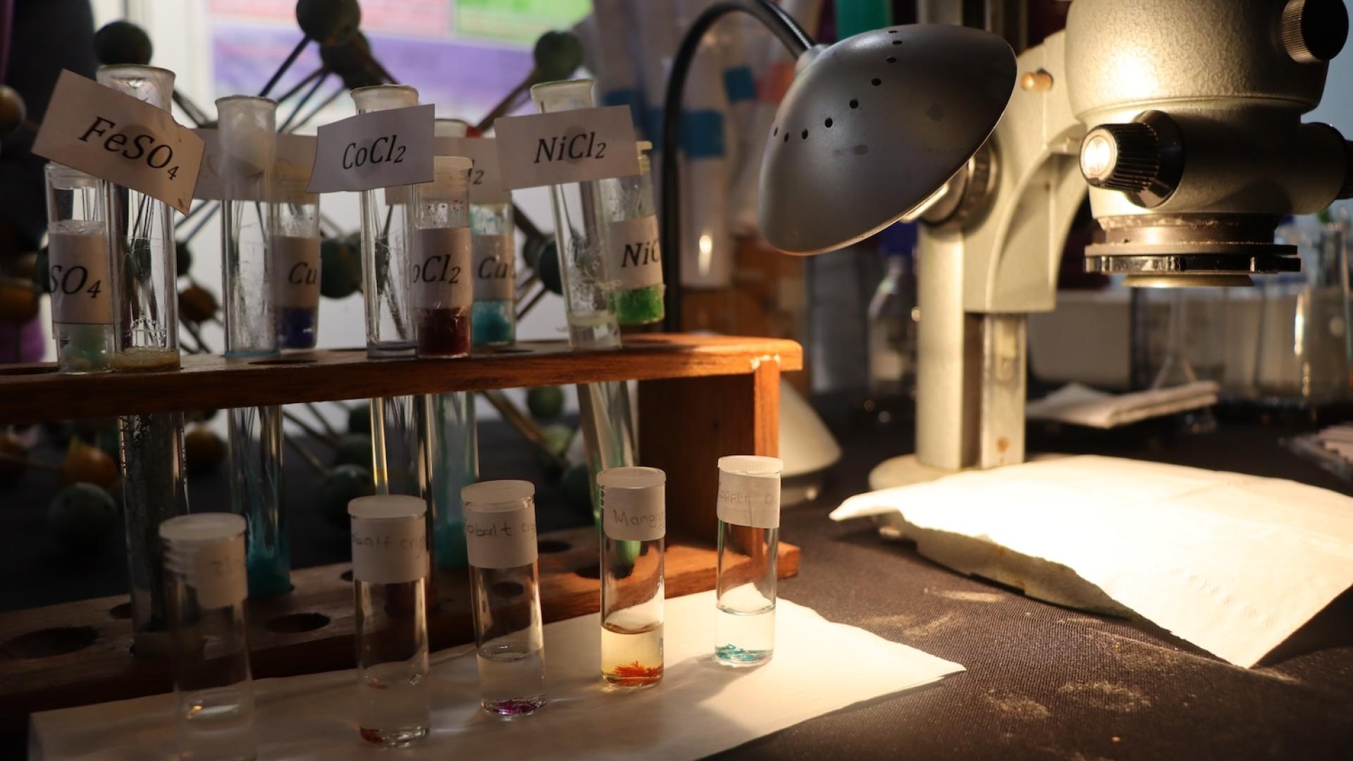Crystal garden and microscope on the chemistry exhibition table