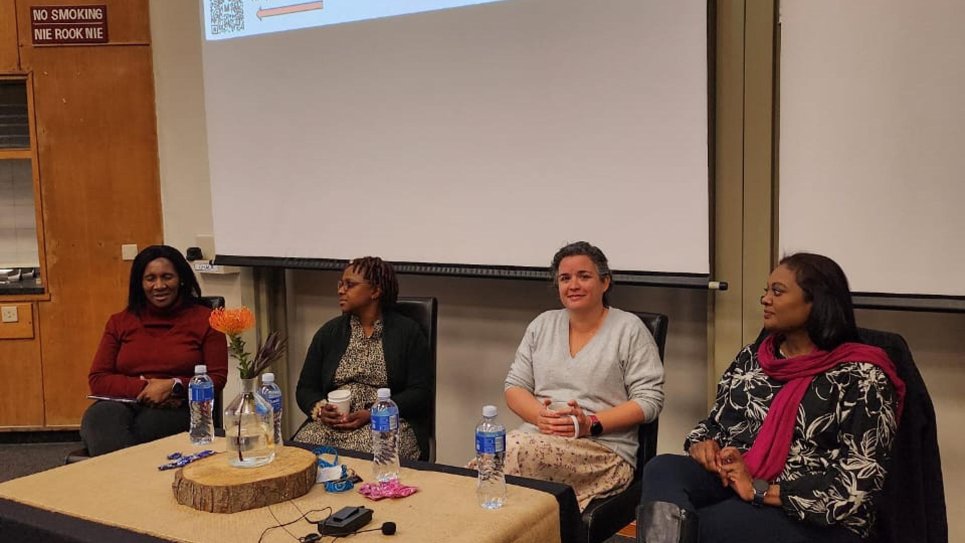 Panel discussion on women in chemistry with four panelists and event title on screen.