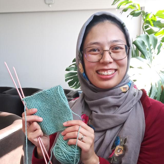Laa-iqa holding up her knitting