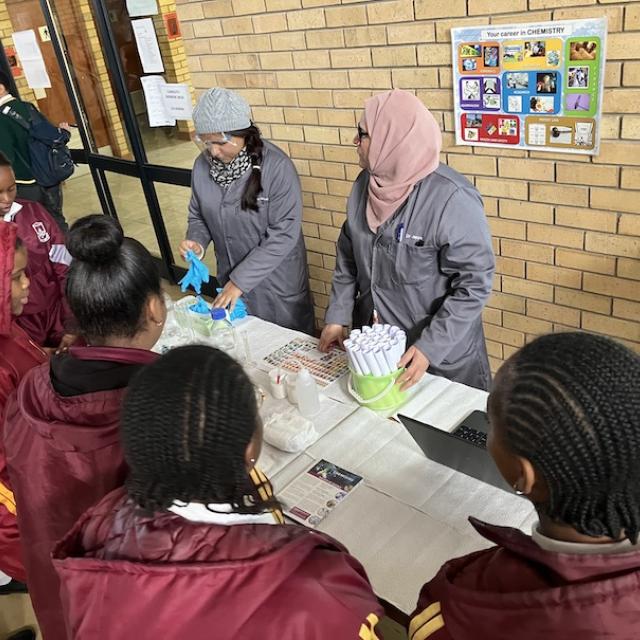 Two scientists showing learners some fun chemistry experiments
