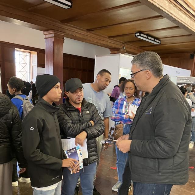 Dr Oliver advising a learner and parent on opportunities available with a BSc. Chemistry Major
