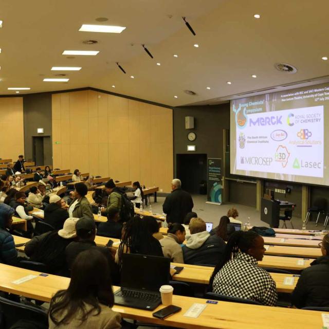 Attendees entering the lecture venue and eagerly waiting for the programme to start.