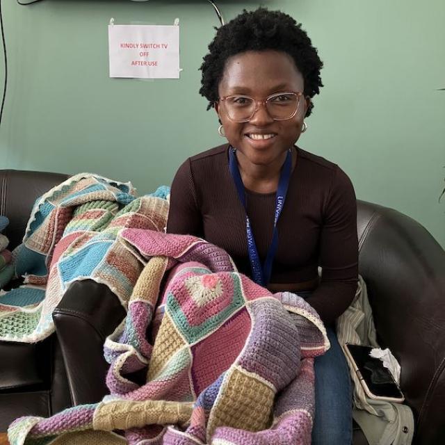 Gciniwe showing off her knitting