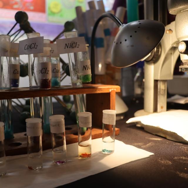 Crystal garden and microscope on the chemistry exhibition table