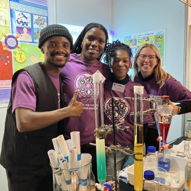 Postgraduate students pose for a picture at the chemistry exhibition table at UCT Open Day
