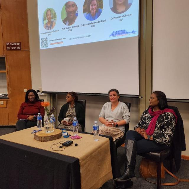 Panel discussion on women in chemistry with four panelists and event title on screen.