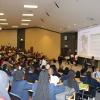 People sitting in an auditorium watching a screen