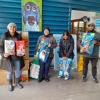 Team holding food items for animals at the shelter